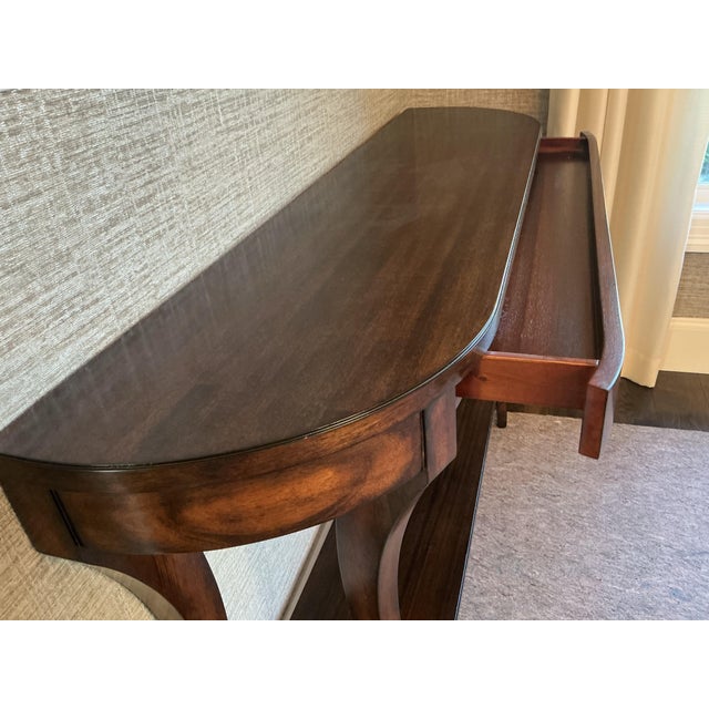 Pair of Mahogany Woodbridge console tables. 56 inches. Small drawer. Mahogany veneers. Like new. Barely used. Can be sold...