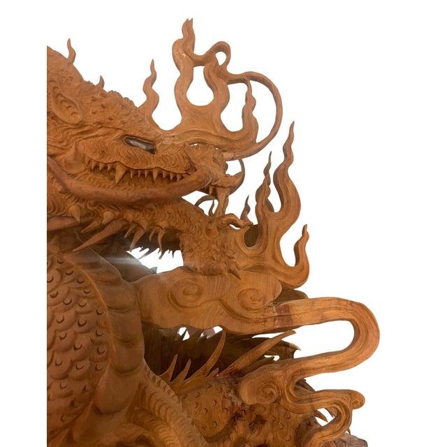Monumental hand-carved Vietnamese wooden dragon sculpture depicting the traditional “Nhất Long Vờn Ngọc” motif, or single...