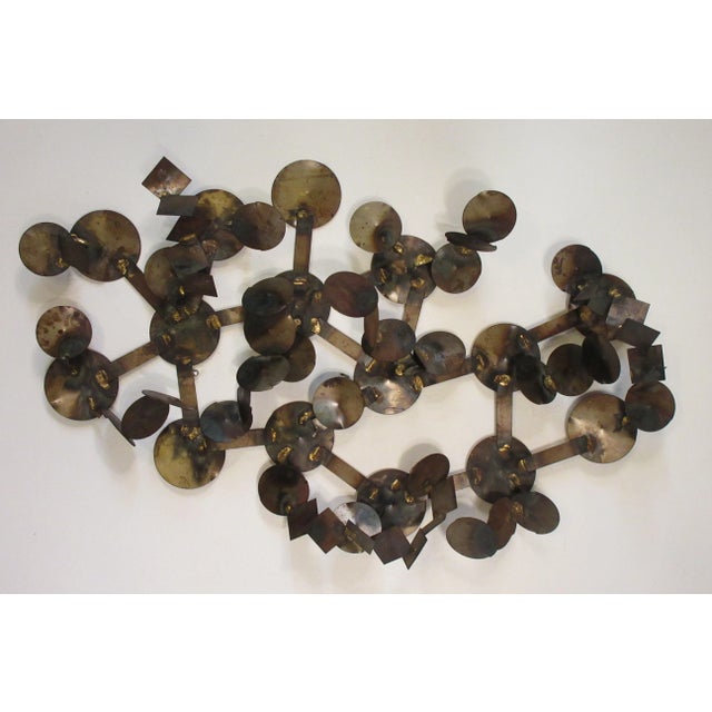 1970s metal circular wall sculpture.