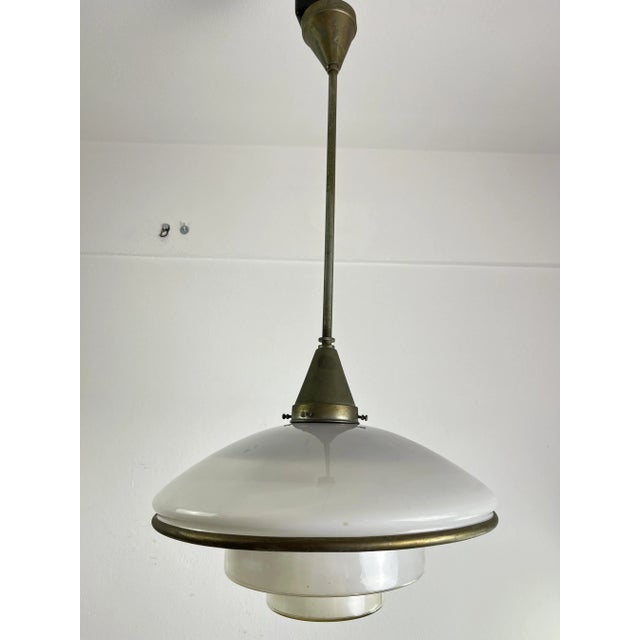 This pendant lamp was designed by Otto Müller in 1931 and produced by Megaphos/Sistrah Licht GmbH in Germany. It is...