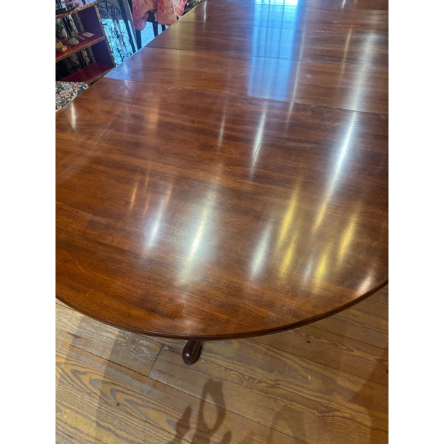 Henkel Harris Georgian-style solid cherry wood double pedestal extension dining table. Each leaf measures 12” deep. Table...
