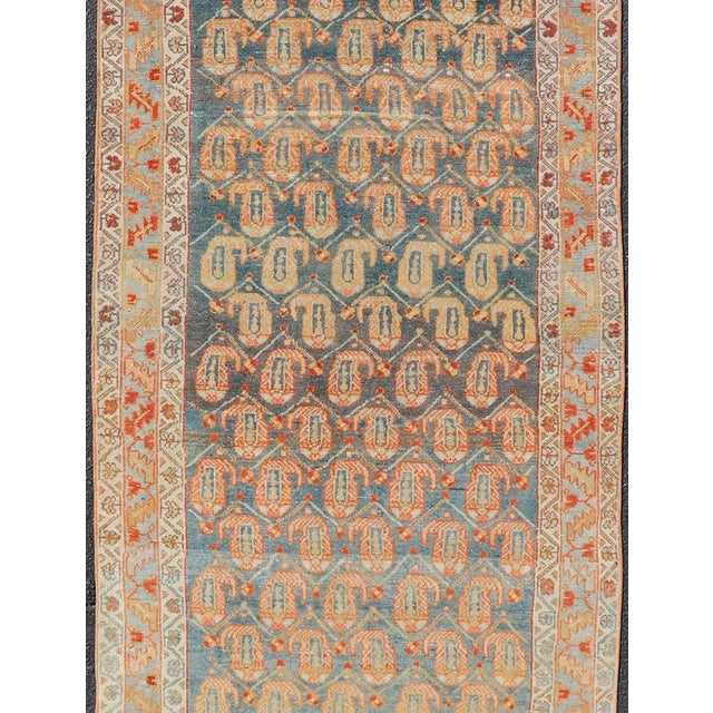 Measures: 3'6 x 16'6. This long antique Persian Malayer runner has been hand-knotted in wool and features an all-over sub-...