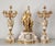 A palatial 3-piece French garniture set of documented "jewelry-grade" quality. Centered by a 32" clock featuring a figural...
