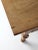 An antique baker’s table dating to circa 1900, often referred to as a “doughboy” or “possum belly” table. Crafted in warm,...