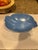 A beautiful mid-century modern Bauer Pottery bowl in a satin matte sky blue glaze, featuring a flowing folded-rim shell...