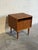 This exceptional vintage nightstand features an open upper shelf paired with a drop-down lower storage cabinet. Exhibiting...