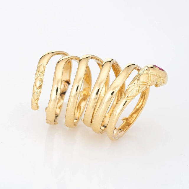 Finely detailed vintage snake ring, crafted in 18 karat yellow gold (circa 1970s to 1980s). Three rubies are set into the...
