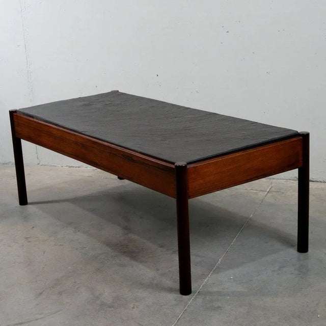 Coffee table featuring a wooden frame with a slate top. The slate is 2cm thick.