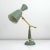 This vintage midcentury table lamp was manufactured in france in the 1950s. It is made of grey lacquered metal and has got...