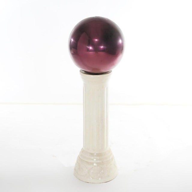 A garden gazing ball offers glass globe on pottery pedestal, 20th century Measures - 35"H x 11.5"Diam A garden piece...