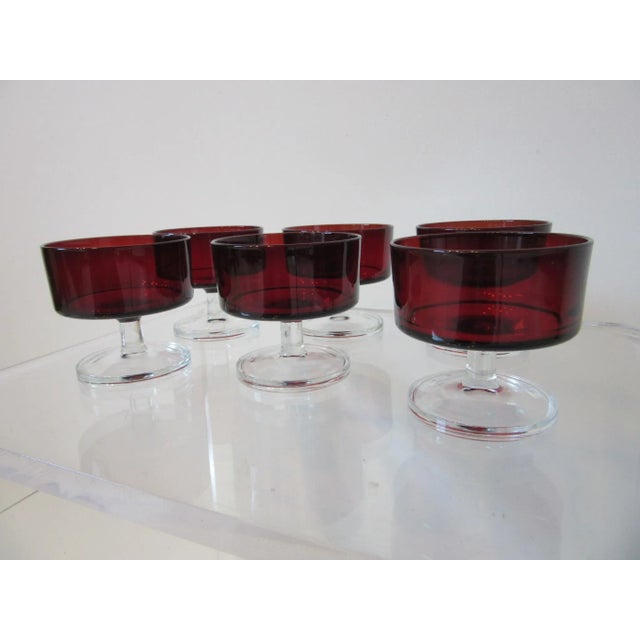 A set of six dark ruby red clear stemmed desert glasses designer attributed to J. G. Durand for the glass manufacture...