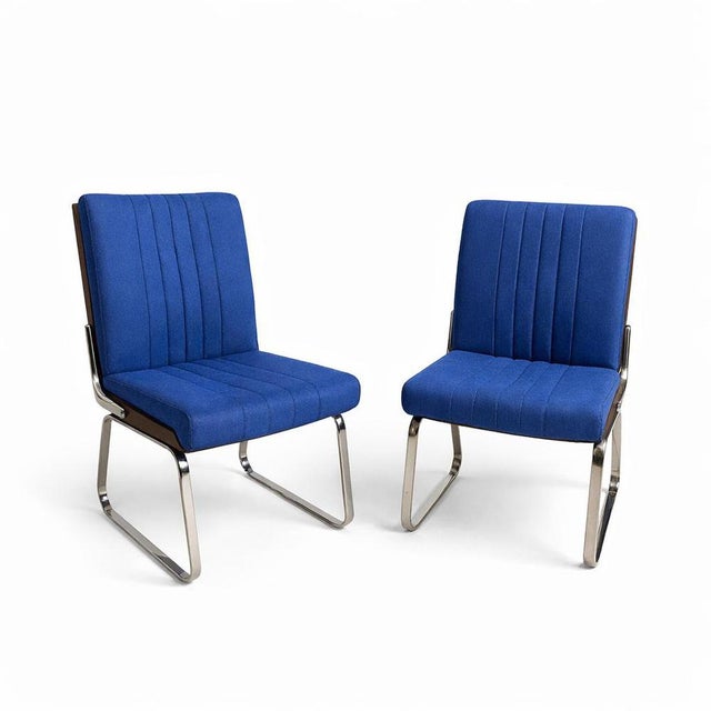 A striking pair of mid-century dining chairs designed by Gordon Russell for Verco, showcasing a confident blend of...