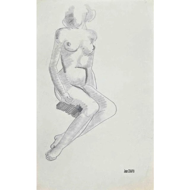 Nude Woman is a pencil and charcoal drawing realized by Jean Chapin in the 1950s. Signature stamp on the yellowed paper....