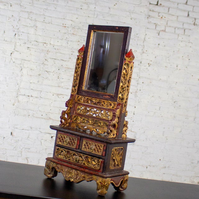 Magnificent vintage Indonesian Maduran tabletop jewelry case or vanity mirror w/chest composed of wood frame with gilded...