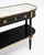 An elegant French Louis XVI style console table constructed in ebonized wood with a white marble top and extensive gilt-...