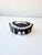 A refined black jasperware jewelry box (matte stoneware) with white slip decorations in relief, produced by the renowned...