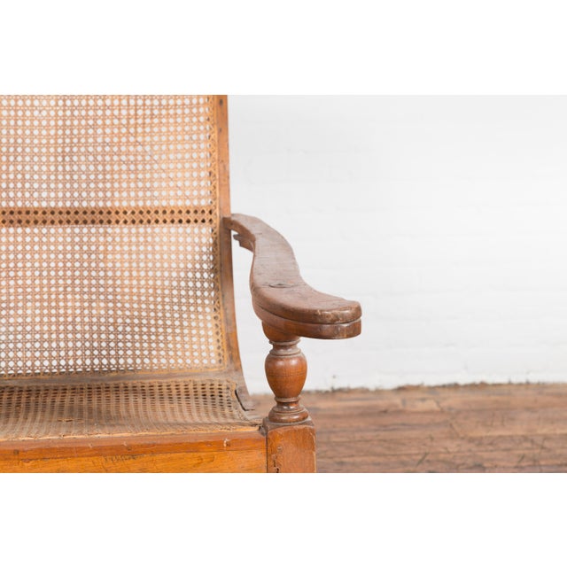 Dutch Colonial Indonesian Cane and Wood Plantation Chair with Extending Arms For Sale - Image 9 of 12