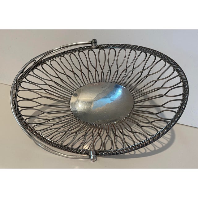Early 19th century old sheffield plate wirework basket. Unmarked, there is an open cartouche on the handle for engraving.