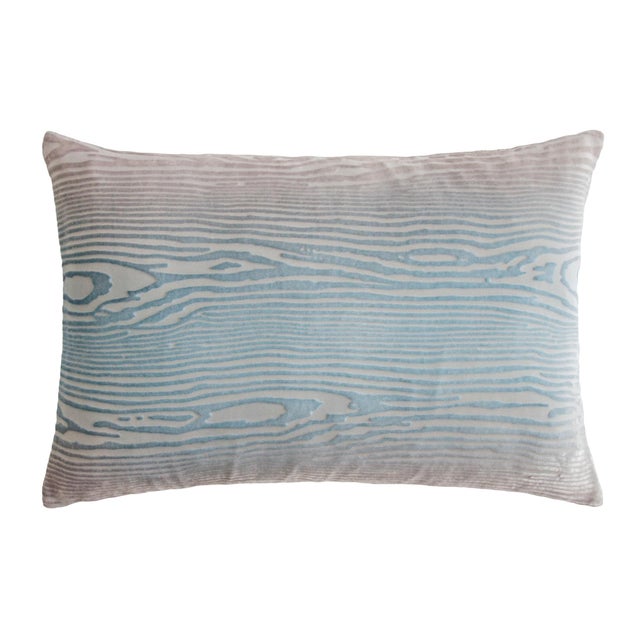 A serene study in restraint, this pillow marries the soft aquamarine of robin's egg with warm woodgrain undertones,...
