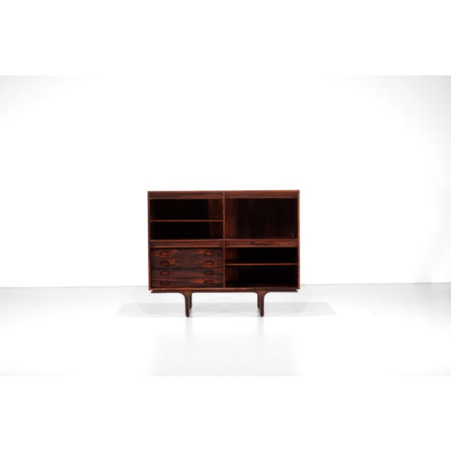 High wooden sideboard, model 504, featuring four exceptional revolving doors that conceal ample storage space. Designed by...