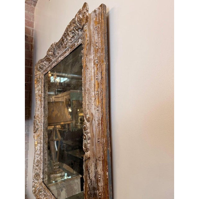 A beautiful French Louis Philippe mirror featuring a richly molded giltwood frame with elegant hand-carved detailing and...