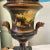 Beautifully detailed metal urn lamp with silk shade. From the floral design in gold on the base to the lion’s head handles...