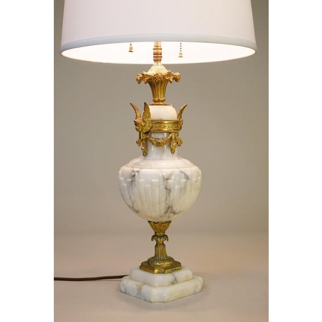A sophisticated and elegant Milky White carved Marble & Brass Gilt Victorian Neoclassical Urn table lamp designed and...