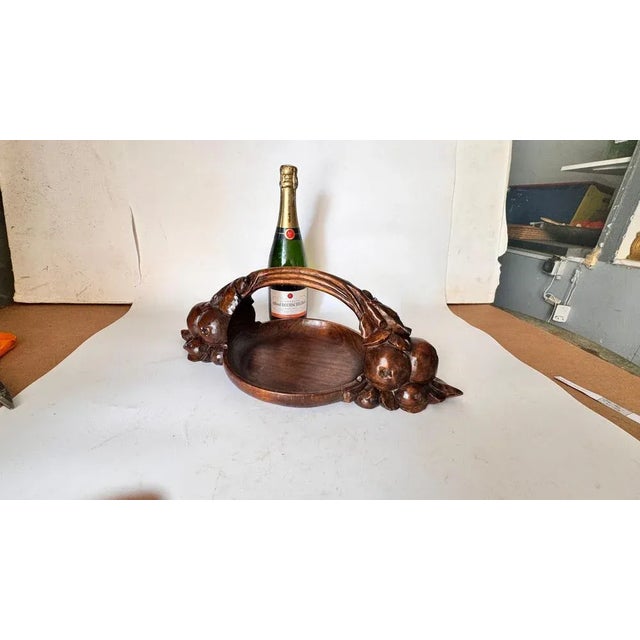 This is a rare Art Deco fruit basket, hand-carved in solid brown wood, likely made in France during the 1930s. The design...