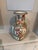 A striking Chinese porcelain vase featuring colorful hand-painted figural scenes set within ornate decorative panels,...