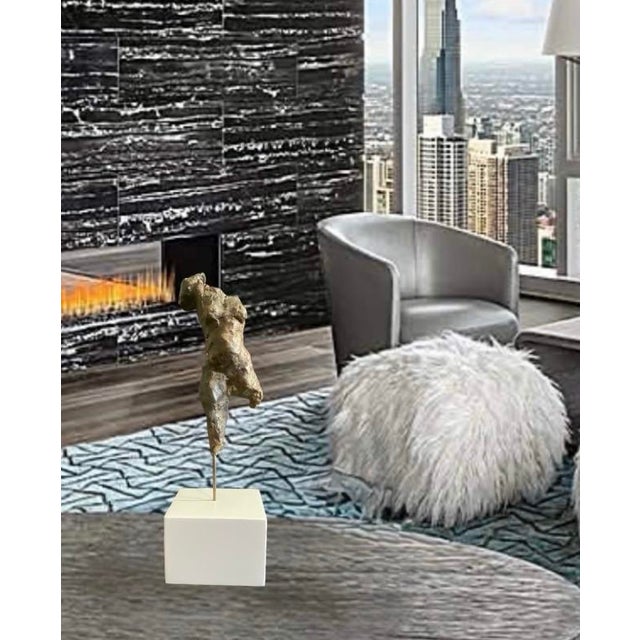 Handsome bronze abstract female sculpture mounted with one single brass rod to a white lacquered wood painted base. It...