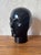 A striking vintage ceramic mannequin head dating from the 1970s, finished in a deep, high-gloss black glaze. with its...