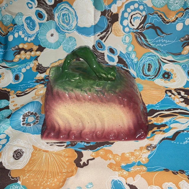 Abstract purple, green, and yellow Majolica cheese lid. I’m not sure exactly what this is meant to be styled after, but...