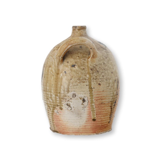 Late 19th century French terracotta jug with a classic provincial form and two high loop handles. The surface shows...