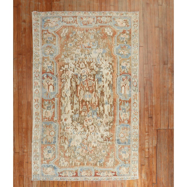 An early 20th Century Russian Karabagh rug with a floral motif in brown, ivory blue, and apricot tones Measures: 4'9'' x...