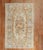 An early 20th Century Russian Karabagh rug with a floral motif in brown, ivory blue, and apricot tones Measures: 4'9'' x...