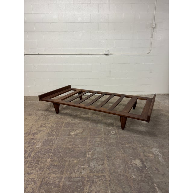 Modernized version of an African Senufo daybed. Made entirely of solid wood with mortise slats and tapered solid wood...