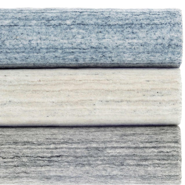 A cool blast of softly striated, sophisticated neutrals adds a dose of chic to any room. Loomknotted in "wool-touch"...