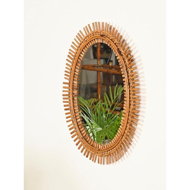 Marvelous French Riviera style oval mirror in bamboo, curved rattan and hand-woven wicker. This elegant and unique organic...