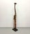 A tall hand-carved wooden giraffe sculpture featuring elongated proportions, hand-painted detailing, and inset circular...