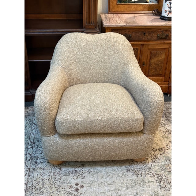 Design Plus Gallery presents the Bacio Lounge Chair from CB2. Boucle takes on camel-colored hues in loungeable chair...