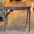 A 19th century French oak side table with a single drawer, a shaped apron, and slender cabriole legs. The plank top has a...