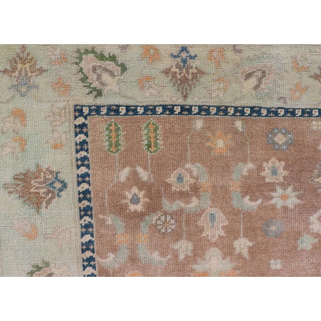 Salmon Mid 20th Century Colorful Turkish Oushak Rug in Salmon Background With All-Over Floral Design For Sale - Image 8 of 13