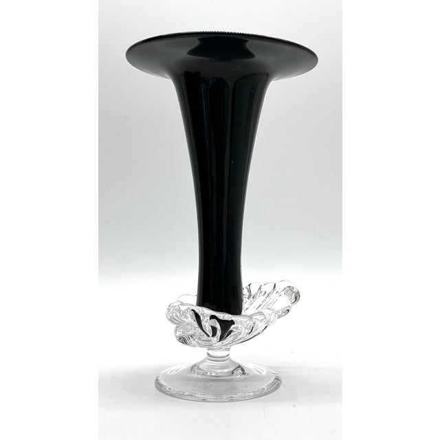 This elegant vintage glass vase combines a deep black, glossy chalice shape with an artfully crafted clear glass base. The...