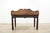 Vintage Federal style console table featuring a warm mahogany-toned finish, elegant fluted taper legs, and a sculptural...