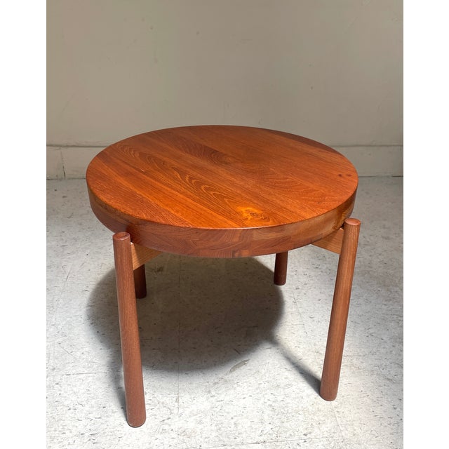 This is a versatile and beautiful tray table in solid teak. The table features a removable and reversible top that is...
