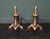 A pair of 18th century Dutch brass and wrought andirons. The vase shaped finials are supported on scroll feet faced with...