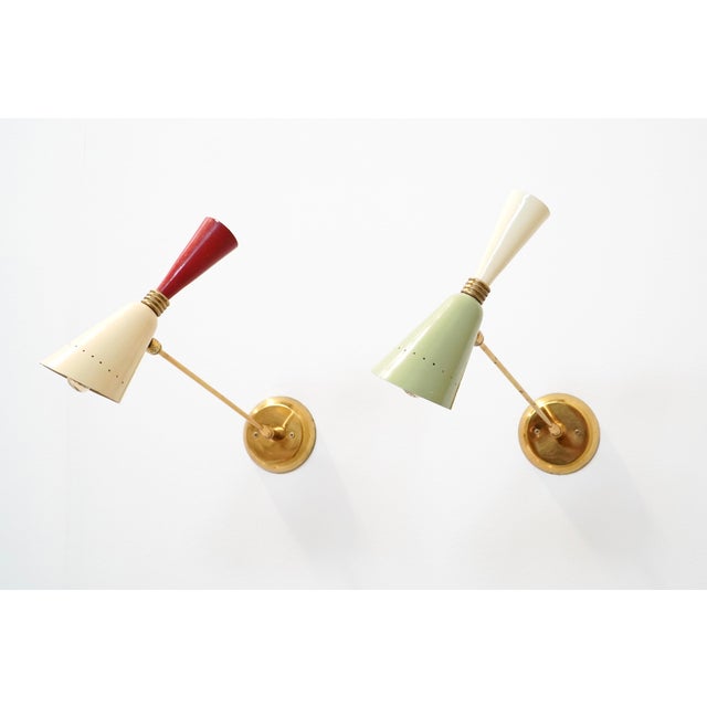 Full of charm and character, this set of 1950s Italian diabolo-shaped wall sconces, attributed to Stilnovo, is made from...