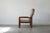 The minimalist teak frame and the wide, upholstered seat and back create a comfortable and striking armchair. The frame...