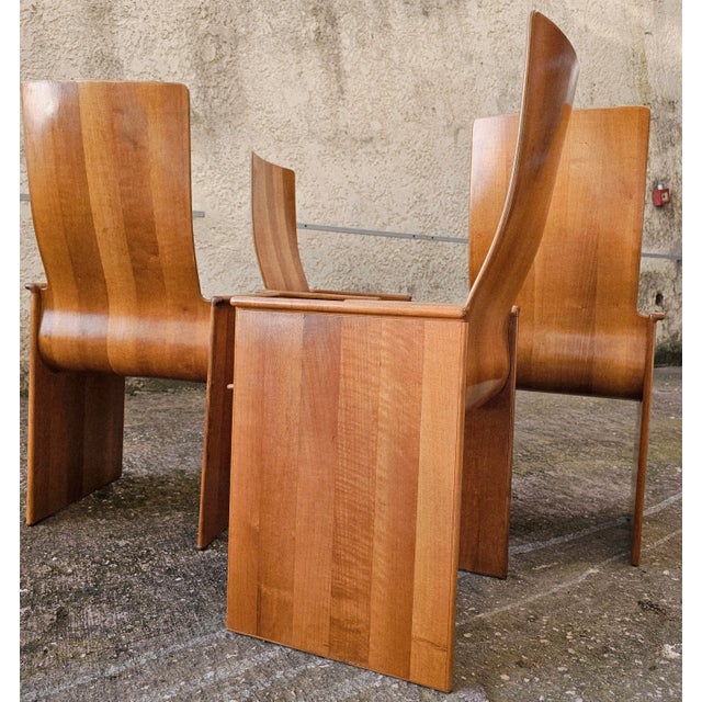 Splendid set of four maple chairs with finely curved seats. Excellent condition with light signs of use. Designed by Afra...