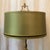 This elegant brass table lamp with a glossy green shade is a real eye-catcher and adds a luxurious touch to any room....